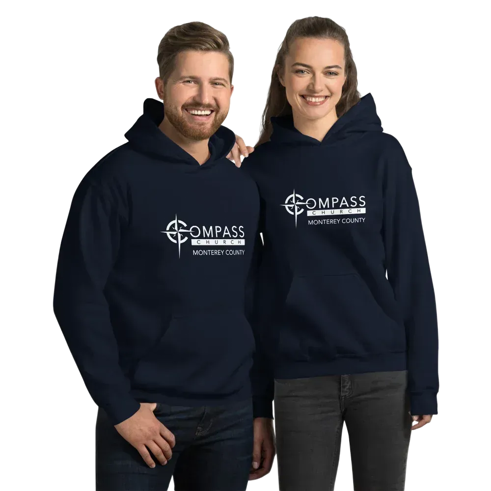 Two people wearing matching navy Compass Church hoodies with the white logo.